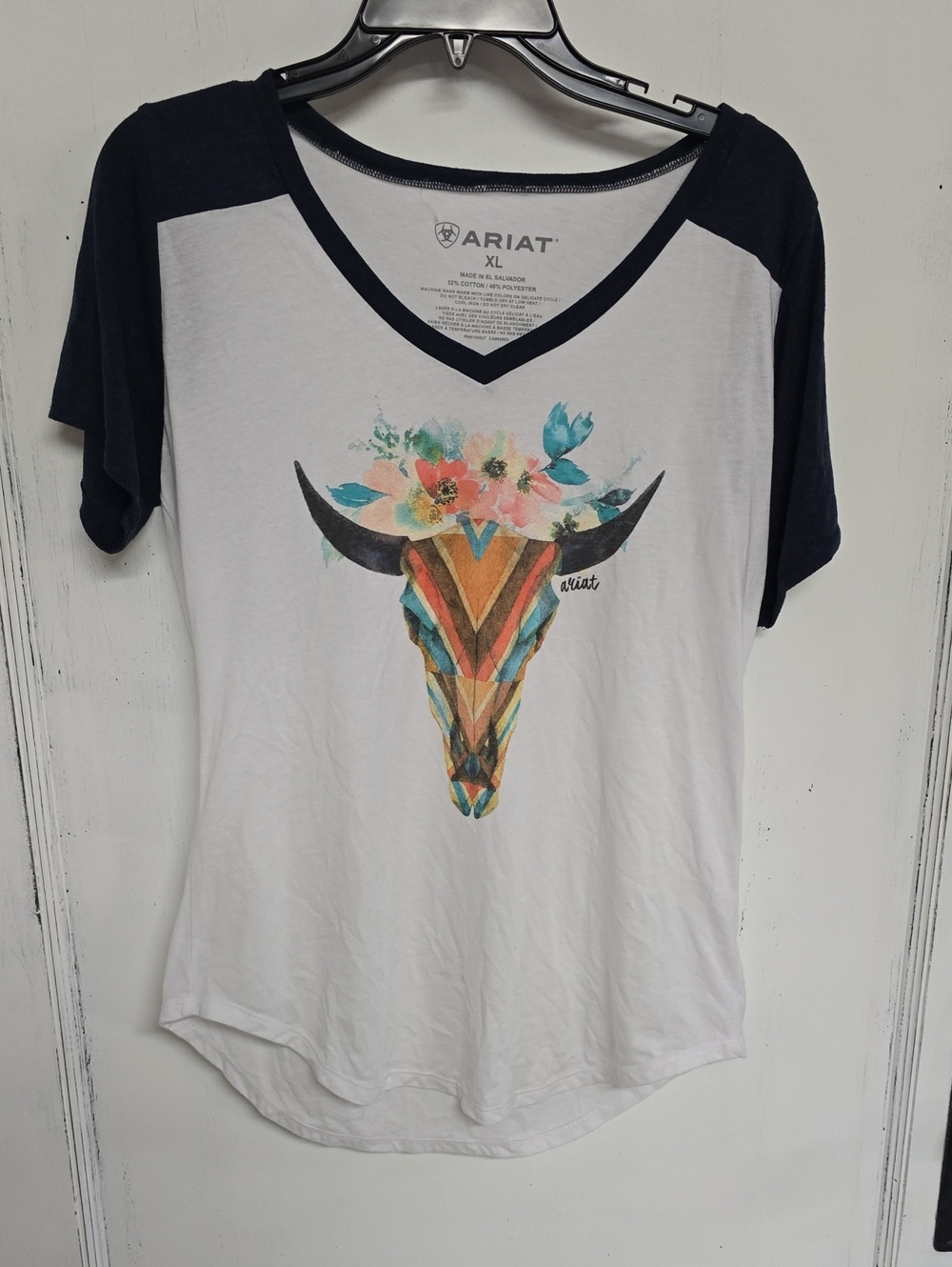 Ariat White V-Neck Tee with Navy Raglan Sleeves and Colorful Floral Bull Skull